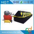 folding hydraulic road blocker for parking